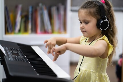 Photo of young child playing keyboard